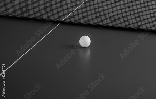 Tennis ball on the table. Black and white image.