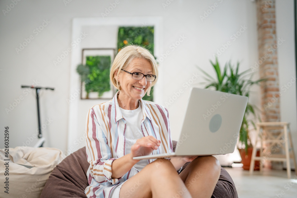 One woman mature caucasian female use laptop computer for work One woman mature caucasian female use laptop computer for work