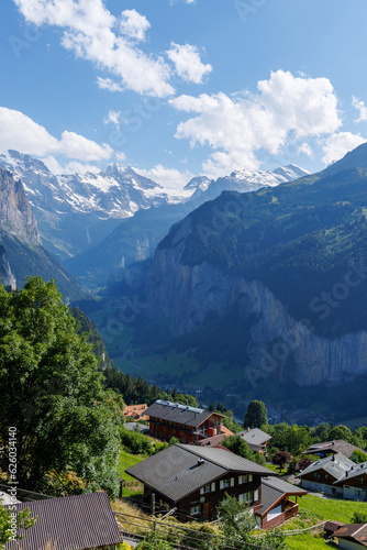 A view of the Swiss Alps and the village of Lauterbrunnen in the Berner Oberland area of Switzerland  with mountains in the background  a valley and chalets in the foreground