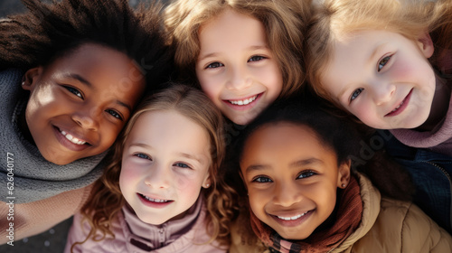 Group of diverse kids smiling at camera, top view