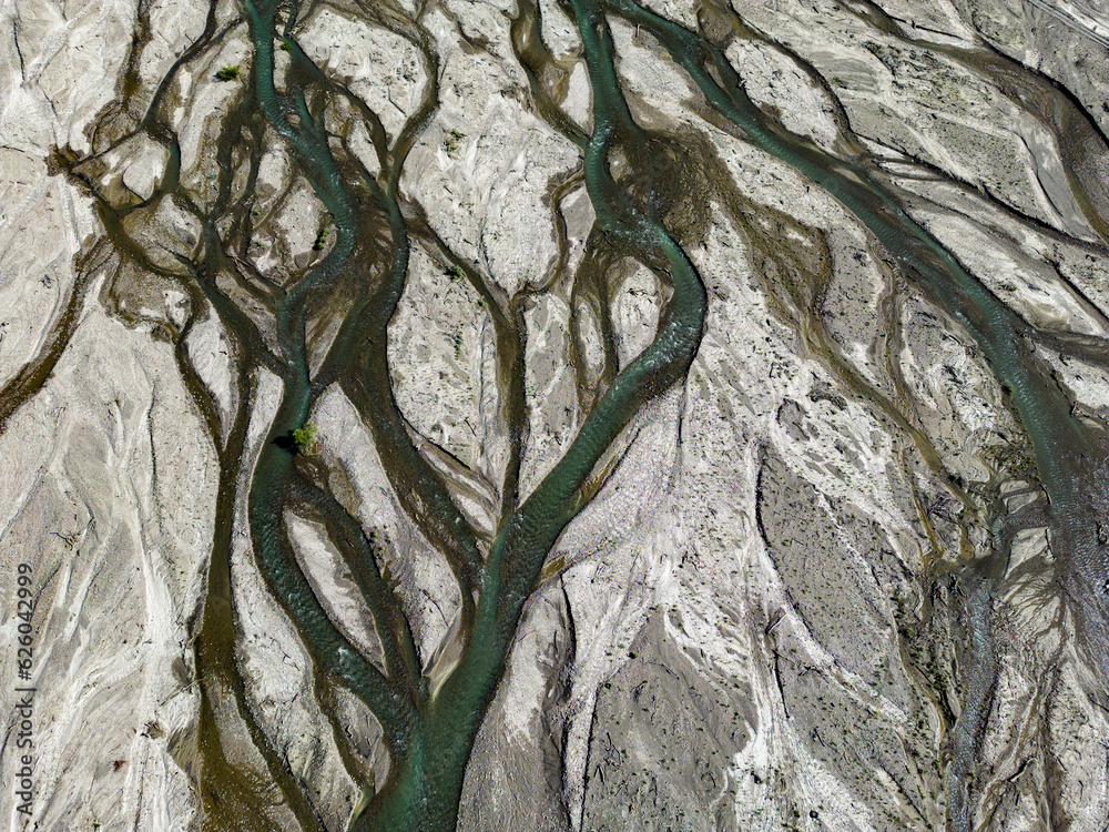 Close up aerial view of the Rio Sacambaya landscape with a huge riverbed and river channels branching in the Bolivian Andes in South America