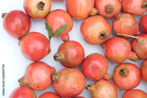 Many red ripe pomegranate fruits as background