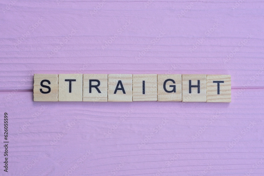 word straight from small gray wooden letters lies on a pink background word straight from small gray wooden letters lies on a pink background
