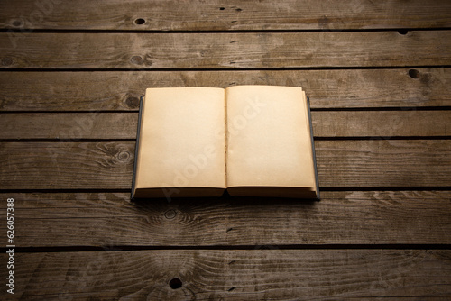Vintage book, open, on old wooden table, with clipping path. Open Book blank on old wooden back. book with blank pages