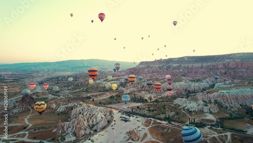 Drone point of view footage of hot air balloons above spectacular volcanic landscape of Cappadocia. Goreme national park. UNESCO World Heritage site. Nevsehir province, Turkiye