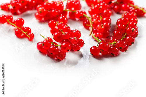 Red currant berries isolated on white background. Fresh and juicy organic redcurrant berry macro shot. Tasty vegan food border design