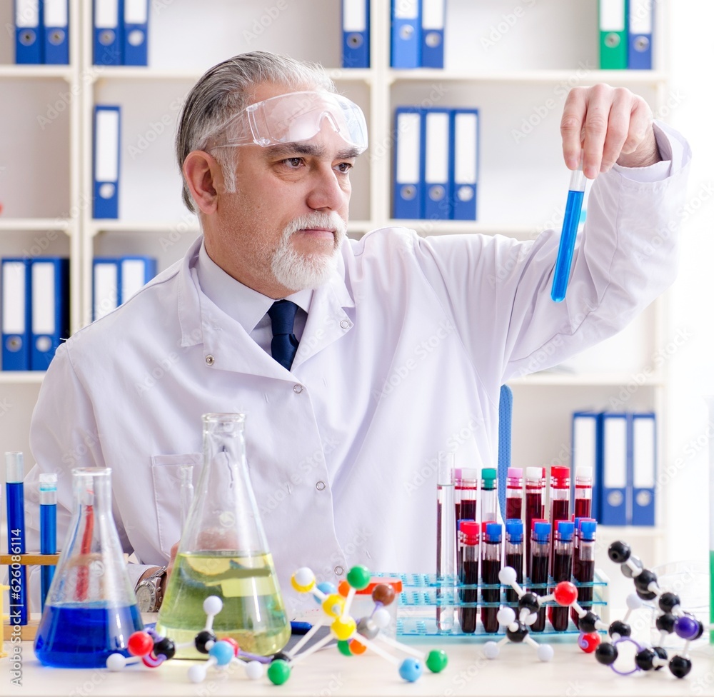 Old male chemist working in the lab Old male chemist working in the lab