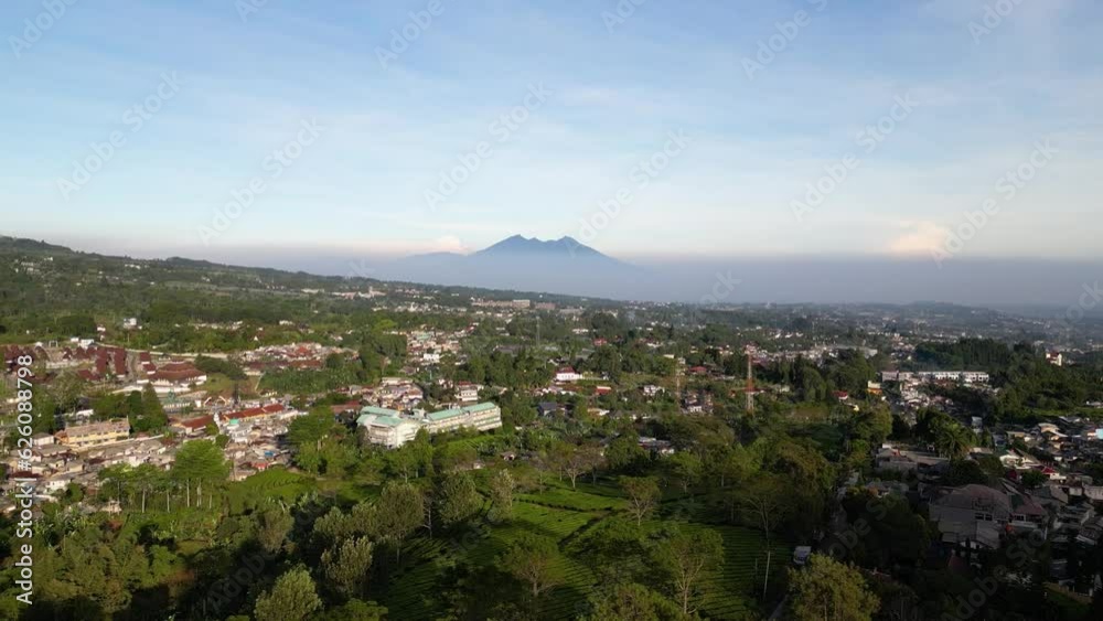 Deforestation. Aerial view of Indonesian forests that are used as housing by humans with Mount Salak in the background. Global warming, climate change, ecology Deforestation. Aerial view of Indonesian forests that are used as housing by humans with Mount Salak in the background. Global warming, climate change, ecology