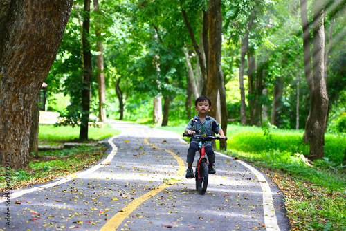 Wallpaper Mural Boy riding bike on dirt path in the park Torontodigital.ca