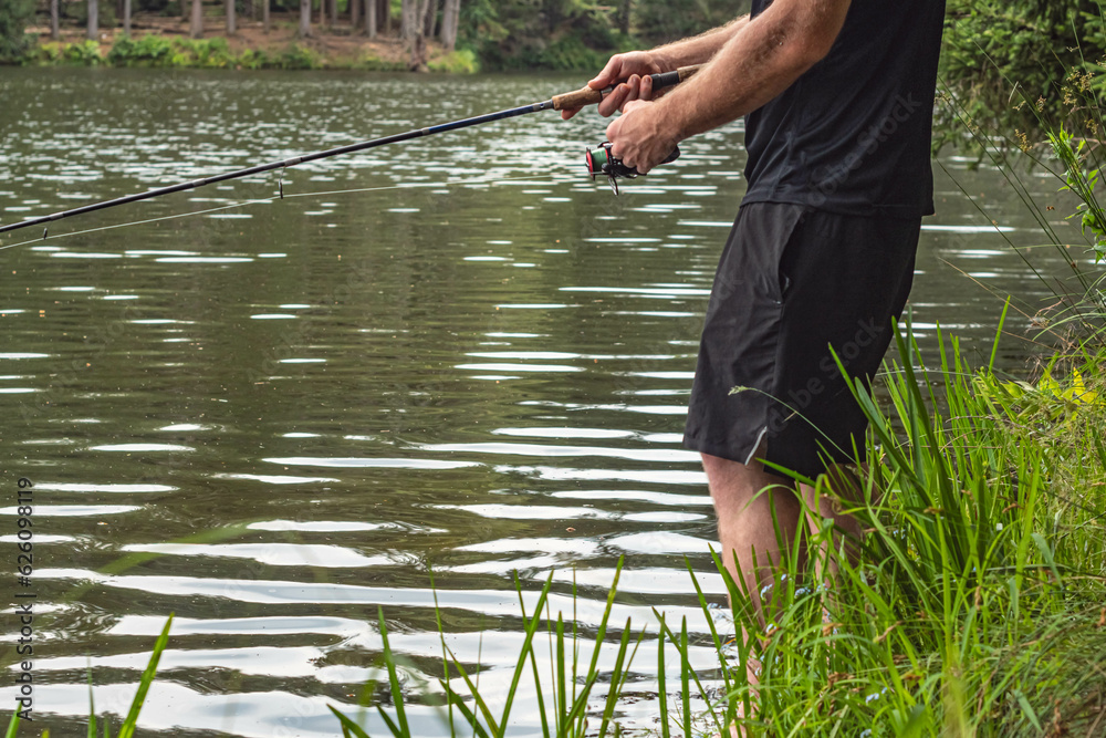 Fresh water lake spring season man shore fishing Fresh water lake spring season man shore fishing