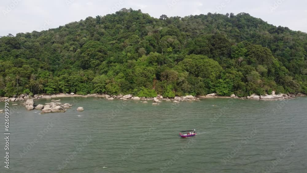 Aerial view fishing boat move at the sea with background of green forest in Pantai Esen, Penang Aerial view fishing boat move at the sea with background of green forest in Pantai Esen, Penang