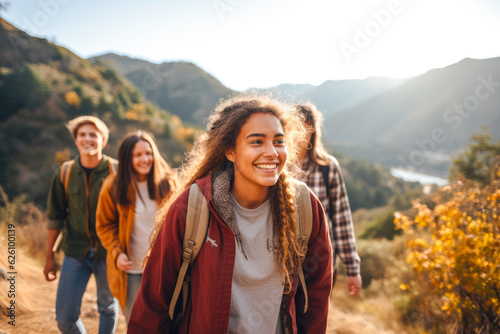 Slika na platnu A group of teenagers hiking and enjoying nature, a group of young friends explor