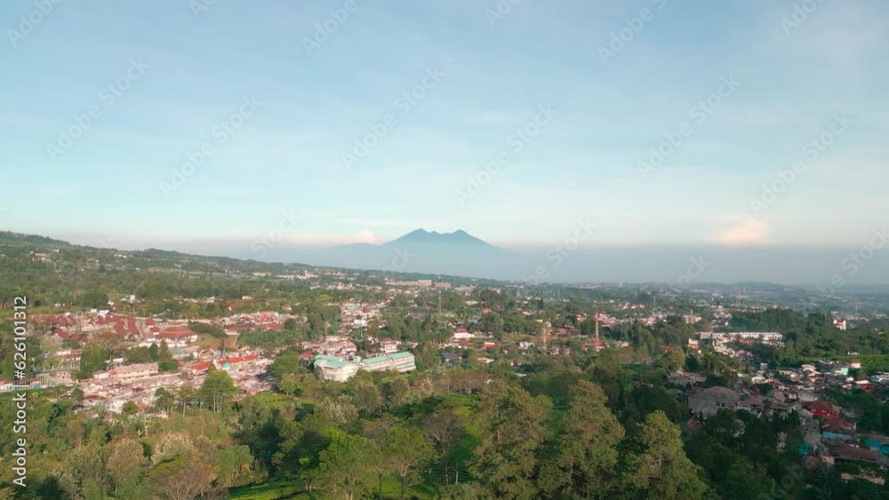 Deforestation. Aerial view of Indonesian forests that are used as housing by humans with Mount Salak in the background. Global warming, climate change, ecology Deforestation. Aerial view of Indonesian forests that are used as housing by humans with Mount Salak in the background. Global warming, climate change, ecology