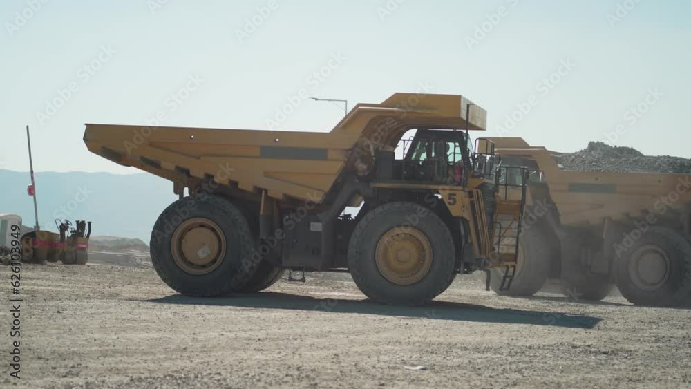 Production useful minerals. Mining dumper truck mining machinery transport ore from open-pit production site, slow motion Production useful minerals. Mining dumper truck mining machinery transport ore from open-pit production site, slow motion