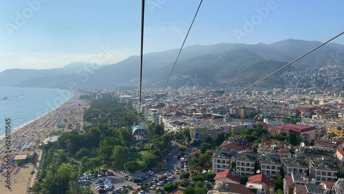 Cable car Alanya Teleferik, Turkey. Cable car cabins with Alanya cityscape, Cleopatra beach, and the Mediterranean Sea in the background. View From the Cable Car Cabins. photo