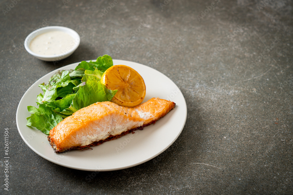 fried salmon steak with lemon and vegetable