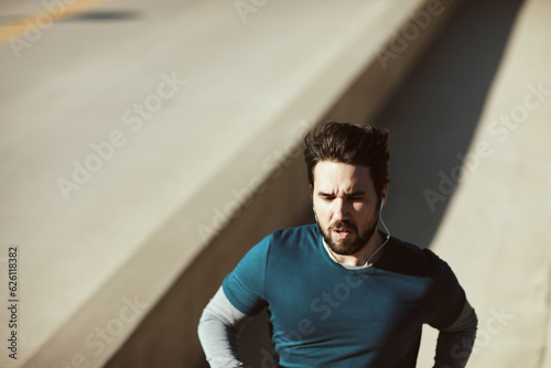 Young adult man jogging on a bridge © Geber86