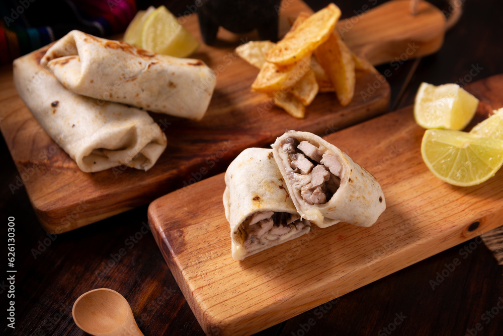 Burritos. Wrapped wheat flour tortilla, can be filled with various ingredients such as scrambled eggs or minced meat, beans and vegetables, a very popular dish in Mexico and the southern USA. Burritos. Wrapped wheat flour tortilla, can be filled with various ingredients such as scrambled eggs or minced meat, beans and vegetables, a very popular dish in Mexico and the southern USA.