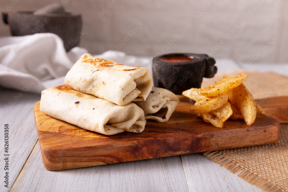 Burritos. Wrapped wheat flour tortilla, can be filled with various ingredients such as scrambled eggs or minced meat, beans and vegetables, a very popular dish in Mexico and the southern USA.