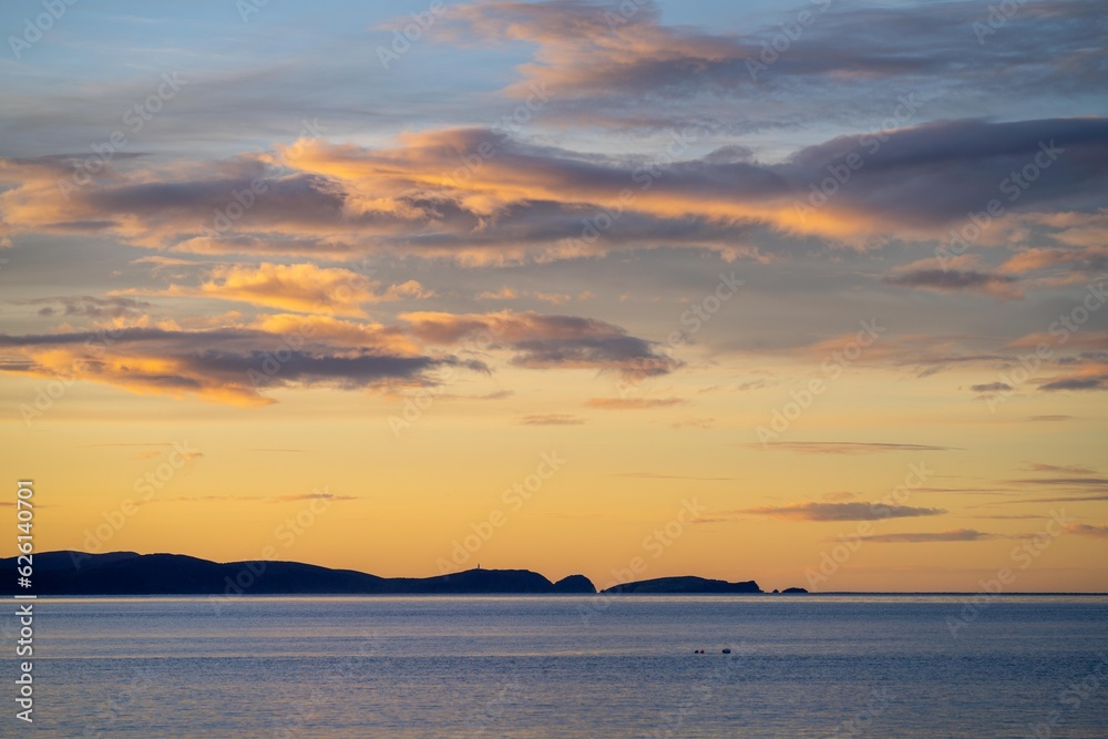 beautiful bruny island at dawn with pink clouds and the ocean below beautiful bruny island at dawn with pink clouds and the ocean below