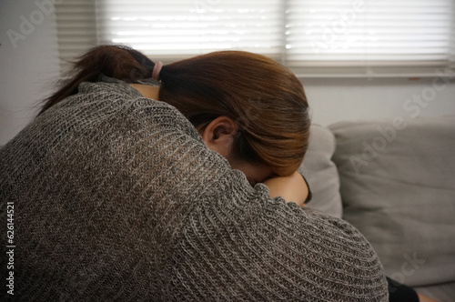 Sad Young woman. Young woman at home living room sofa feeling sad tired.Young woman depressed emotion panic attacks.