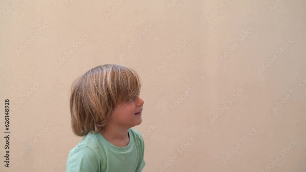Beautiful Blond 3s Boy Playing With Confetti. Child With Confetti And Streamers, Happy And Smiling.Handheld clip