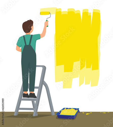Back view man painting on the wall with paint roller