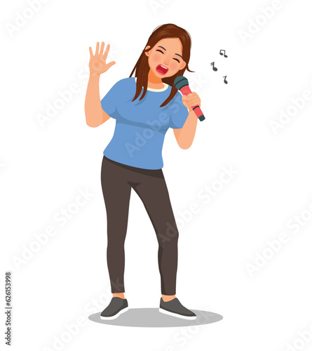 Young woman singer singing song with microphone