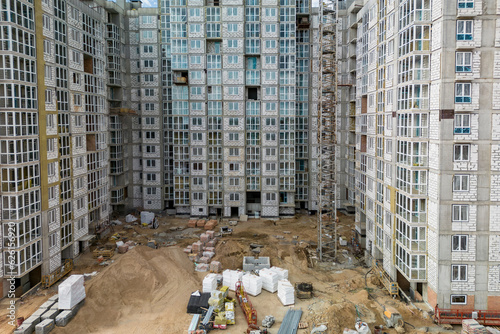 Monolithic frame construction of the building. Family mortgage. Shooting from a drone. Modern construction of a residential building. construction site close up. Multi-storey building. . © Anoo
