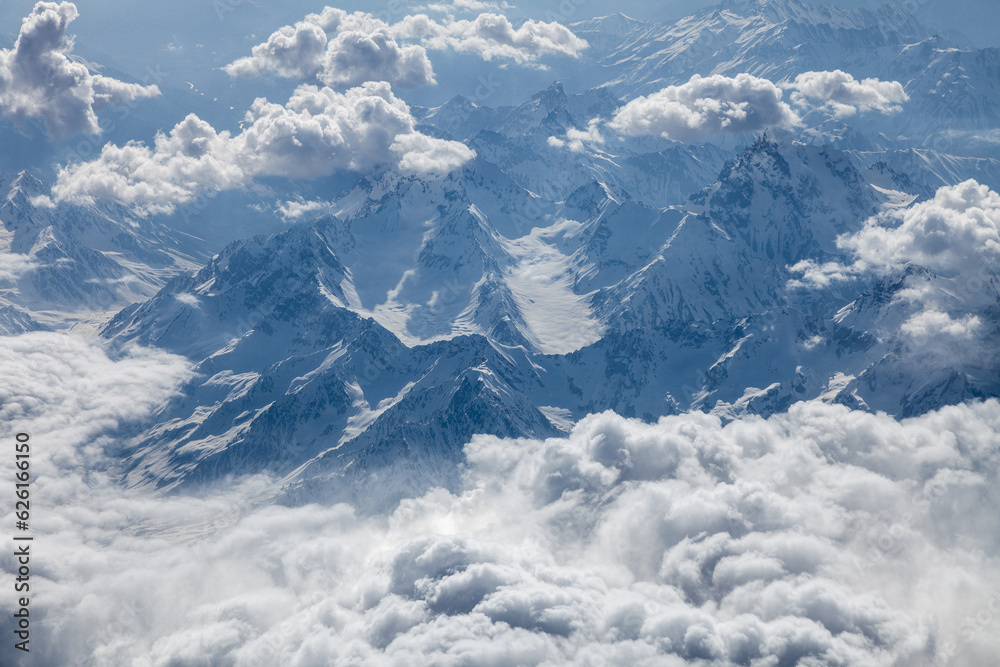 Majestic mountains under velvety clouds, aerial view