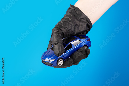 auto theft, a thief in black gloves holds a vehicle