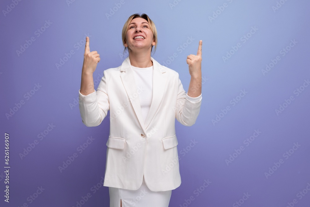 inspired blond young business lady in an elegant jacket talks about an interesting idea