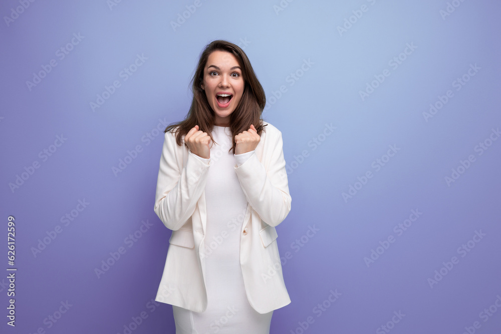 lucky happy brunette woman in dress on studio background with copyspace lucky happy brunette woman in dress on studio background with copyspace