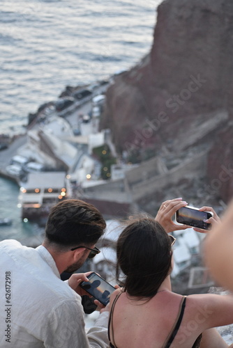 Happy couple taking selfie on vacation in Santorini, Greece.