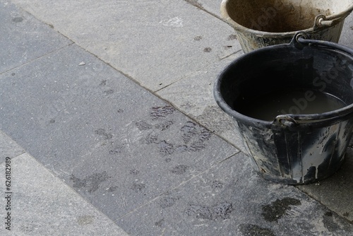 A cement bucket on the floor to preparing work.
