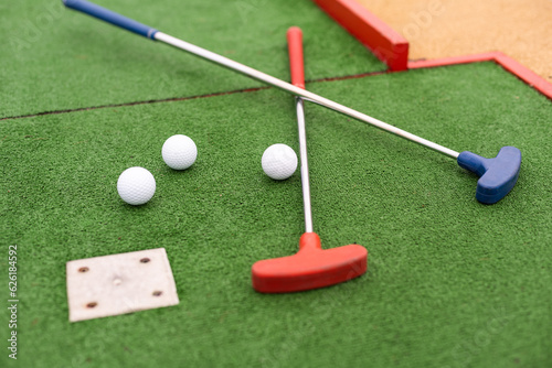 Mini golf close-up, colorful golf putters, balls