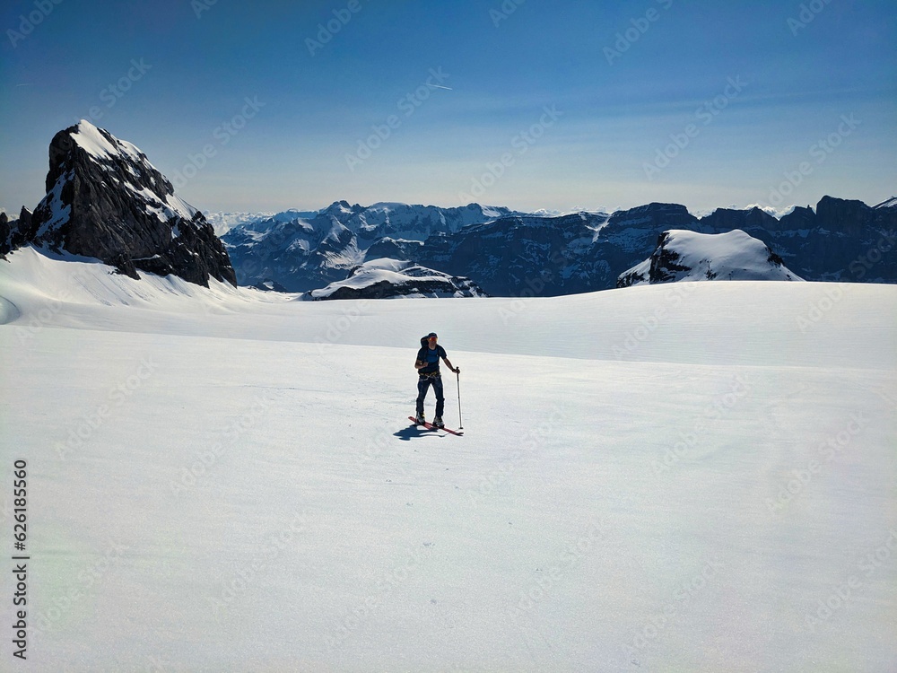 Ski mountaineering ski touring on a mountain top in the swiss alps. Clariden above Klausenpass. snow, ice and glaciers