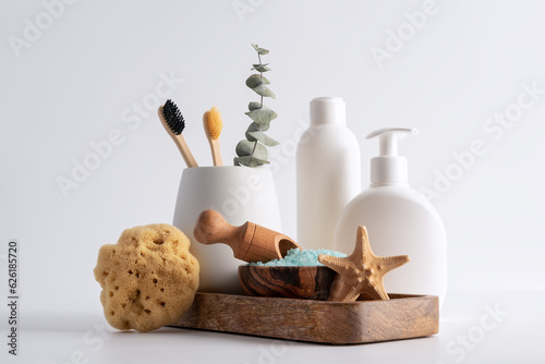 Toiletries and personal hygiene and bath products on white countertop in bathroom