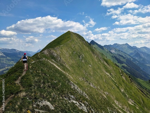 Young woman runs over the Hardergrat above Lake Brienz. Mountain mountain ridge extreme trail running in switzerland. High quality photo