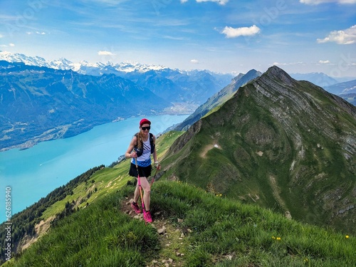 Young woman runs over the Hardergrat above Lake Brienz. Mountain mountain ridge extreme trail running in switzerland. High quality photo