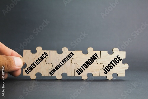 wooden puzzle with the words The 4 main ethical principles. beneficence, nonmaleficence, autonomy and justice.