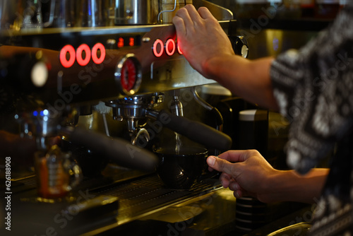Professional barista preparing coffee for customer order in modern coffee shop. Small business, startup coffee shop and restaurant