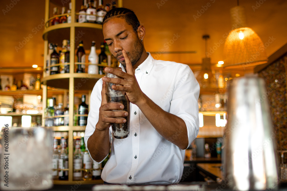 latin bartender working with a shaker