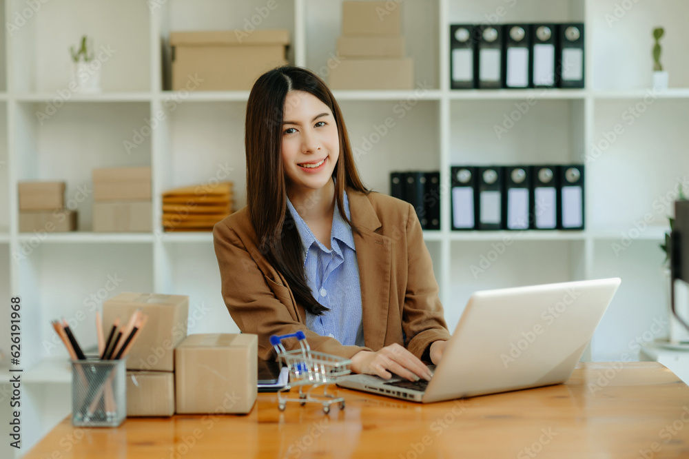 Startup small business SME, Entrepreneur owner woman using smartphone or tablet taking receive and checking online purchase shopping order Startup small business SME, Entrepreneur owner woman using smartphone or tablet taking receive and checking online purchase shopping order