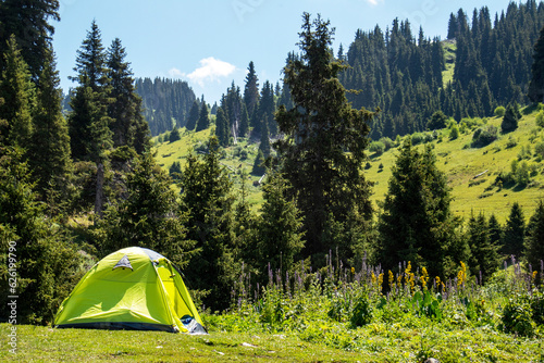 light green tent on the mountain. summer hike