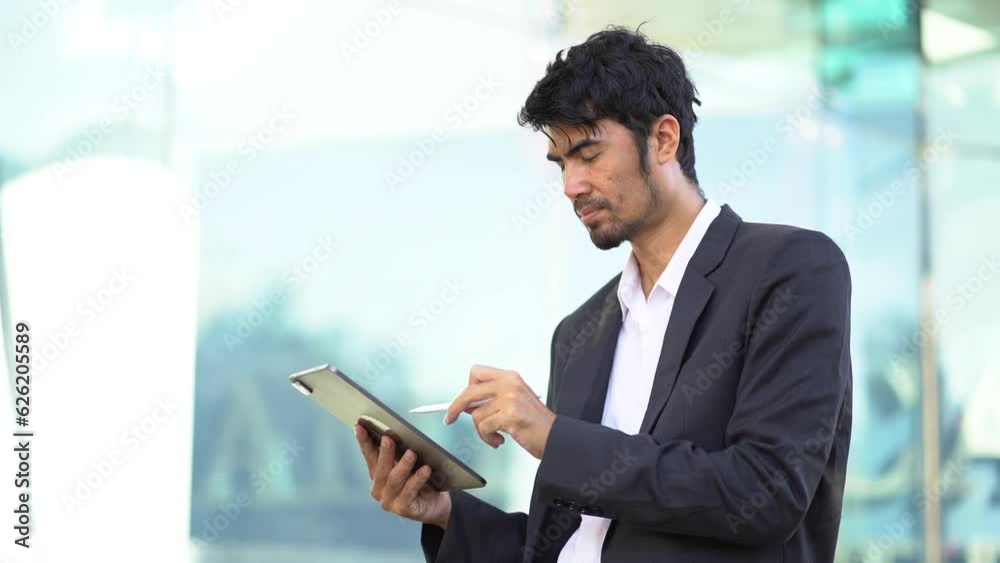 Businessman with digital tablet In hands posing at office, successful businessman using tablet computer. Work place. Lifestyle. Businessman with digital tablet In hands posing at office, successful businessman using tablet computer. Work place. Lifestyle.