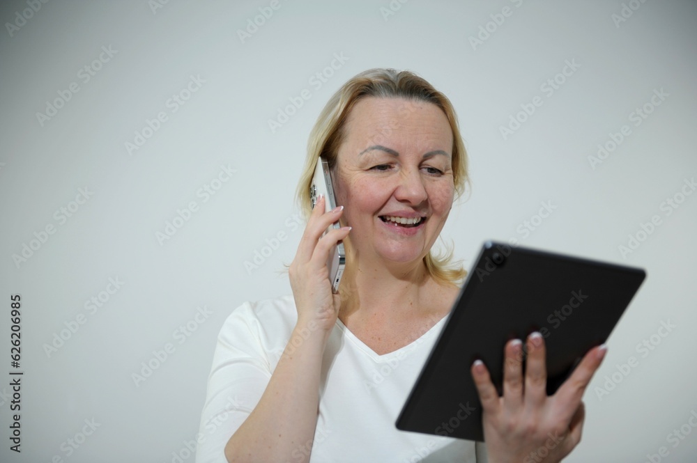 Attractive woman working on a laptop on the couch. Beautiful smiling girl in a red sweater makes purchases or communicates on a social network online, watches movies, freelancer. High quality photo Attractive woman working on a laptop on the couch. Beautiful smiling girl in a red sweater makes purchases or communicates on a social network online, watches movies, freelancer. High quality photo