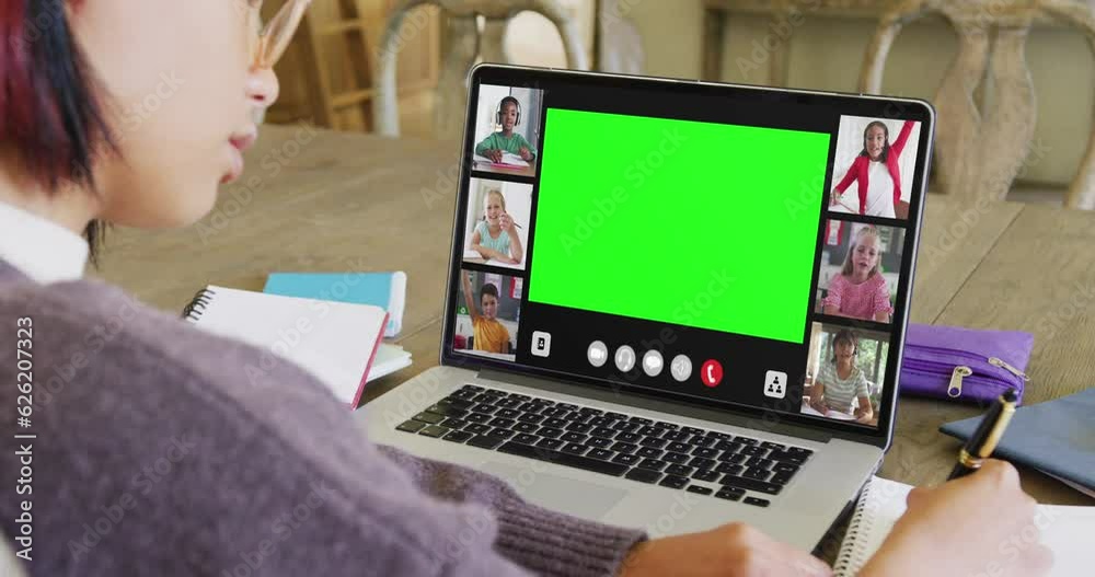 Composition of asian schoolgirl on laptop online learning with green screen, diverse schoolchildren