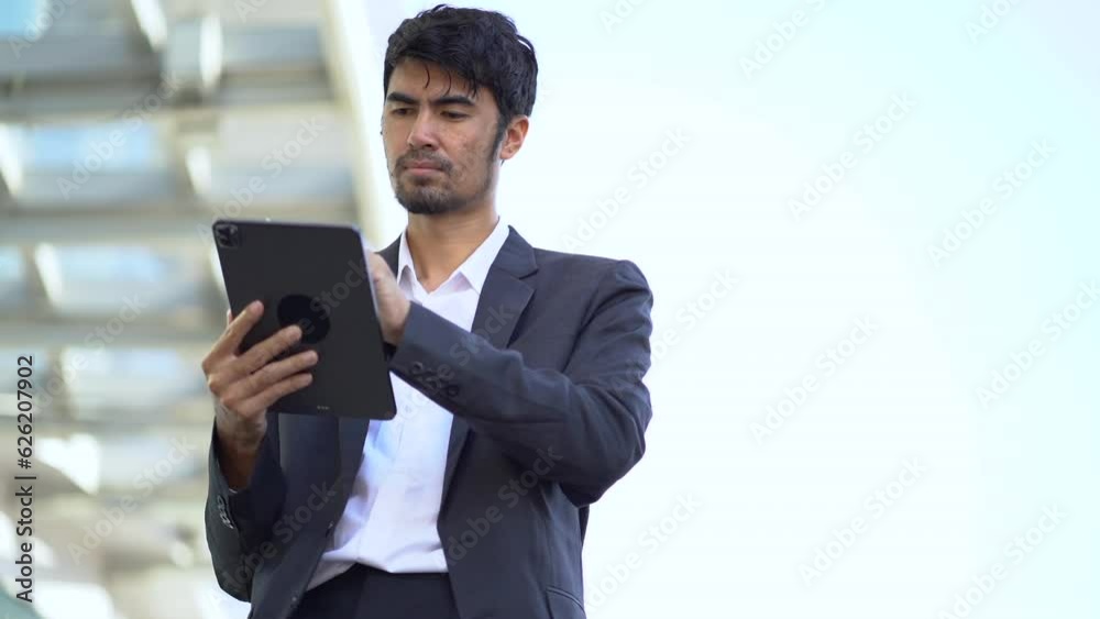 Businessman with digital tablet In hands posing at office, successful businessman using tablet computer. Work place. Lifestyle. Businessman with digital tablet In hands posing at office, successful businessman using tablet computer. Work place. Lifestyle.