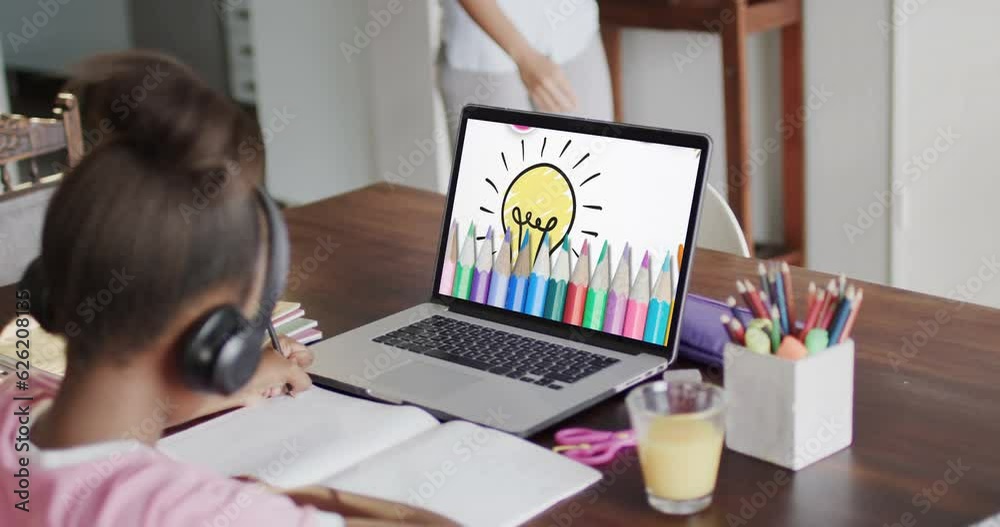 Composition of african american schoolgirl on laptop online learning and crayons Composition of african american schoolgirl on laptop online learning and crayons